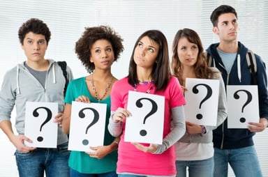 students holding question marks