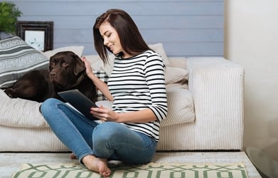 woman in apartment with pet dog