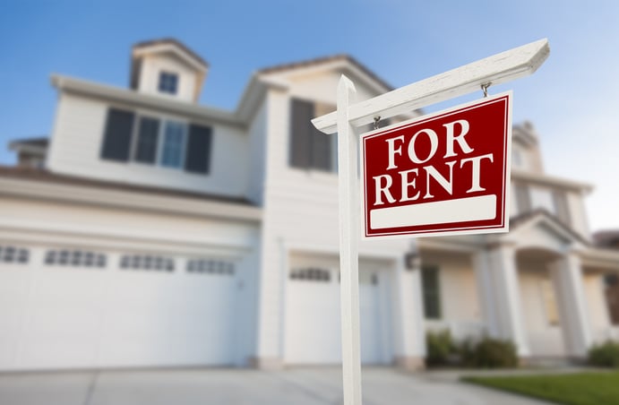 red for rent sign in front of beautiful white single family home 